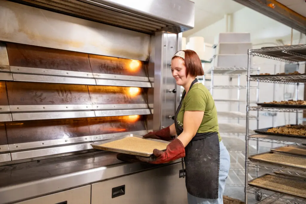 Taking bread out of the oven