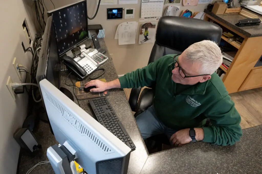 man working on computer at EE Houghton