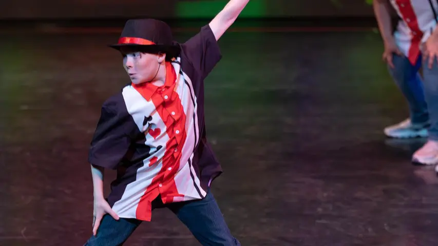 Boy in red and black costume dancing