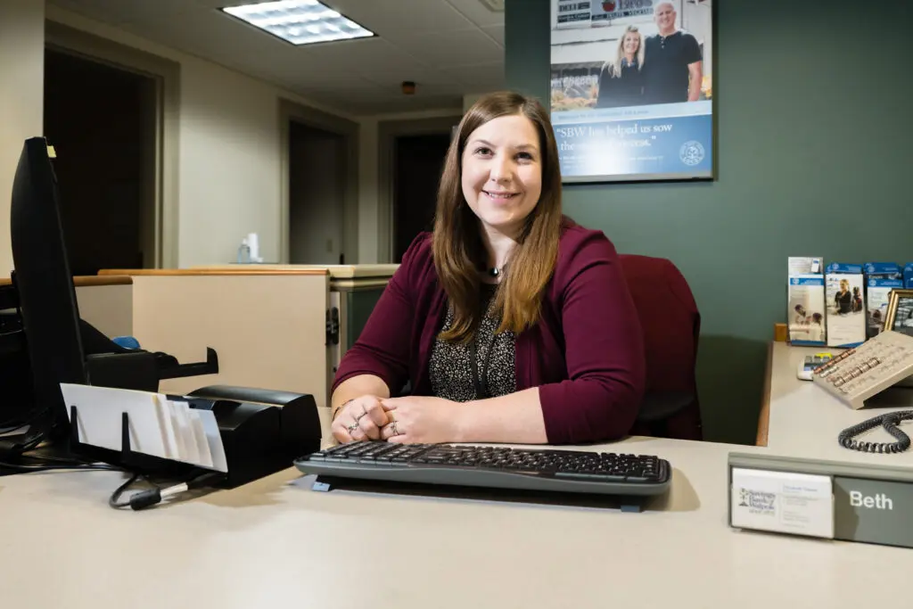 Woman sitting behind desk